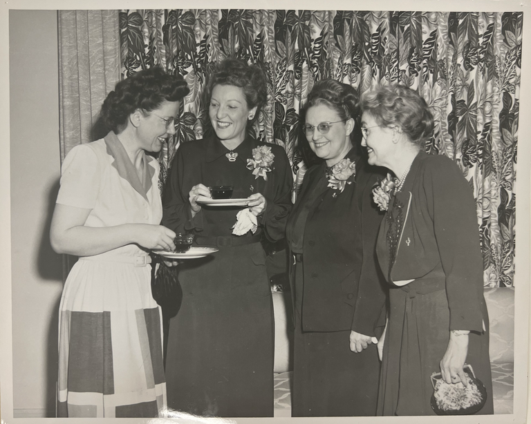1949 At an alumae tea honoring the dean and faculty of the newly formed college, Dean Kitchell is congratulated by three women