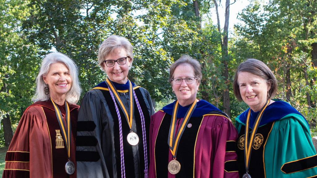 Four professors with robes and medallions