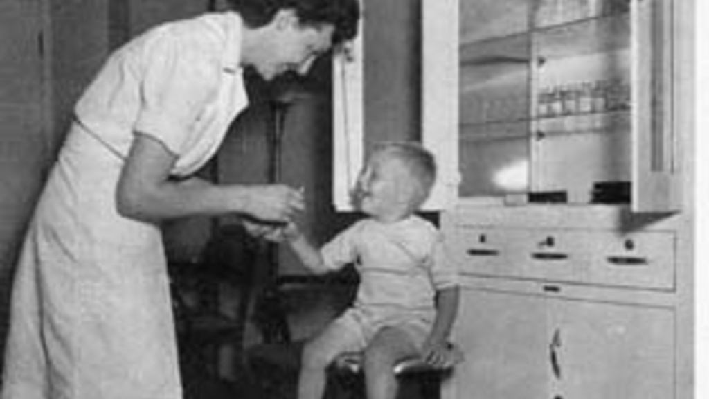 nurse treating small boy